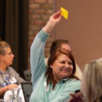 person with yellow paper in air